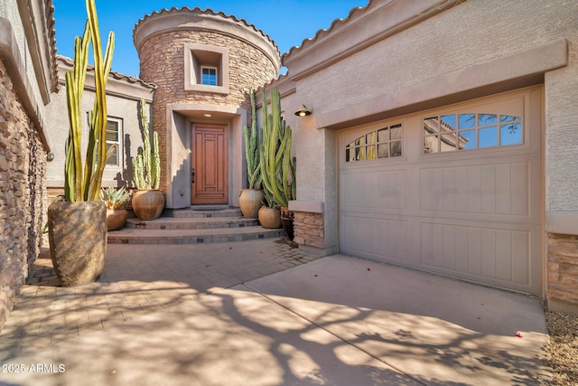 view of exterior entry with a garage