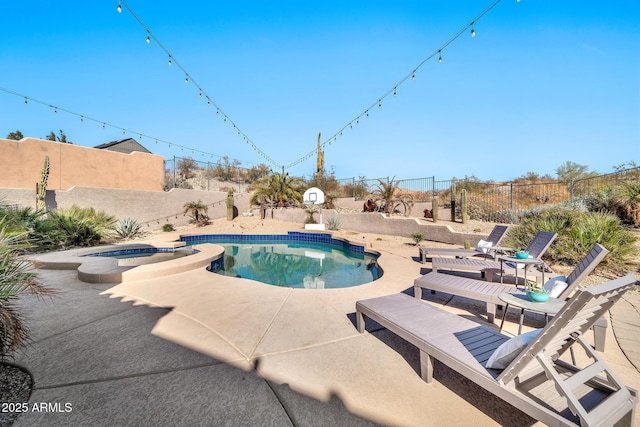 view of pool featuring a patio area and an in ground hot tub