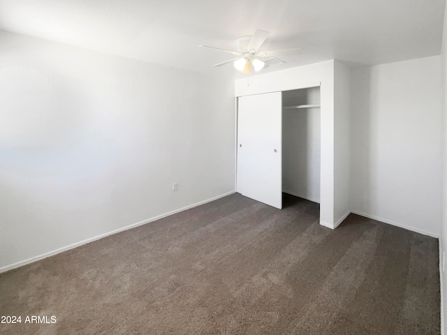 unfurnished bedroom with carpet flooring, ceiling fan, and a closet