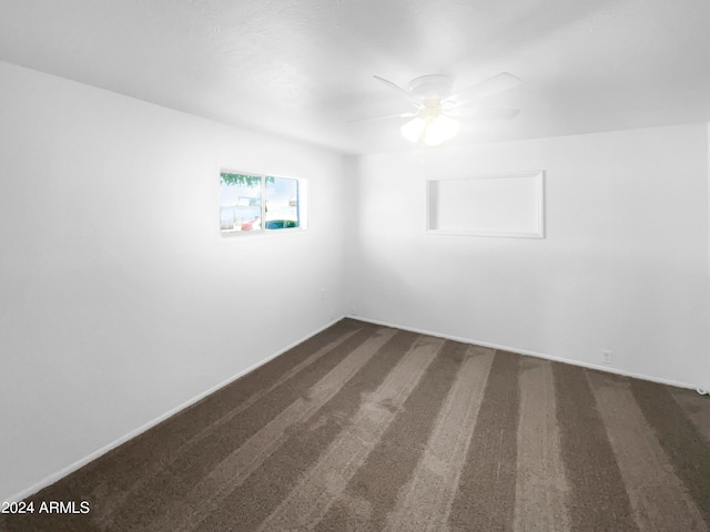 spare room featuring ceiling fan and carpet flooring