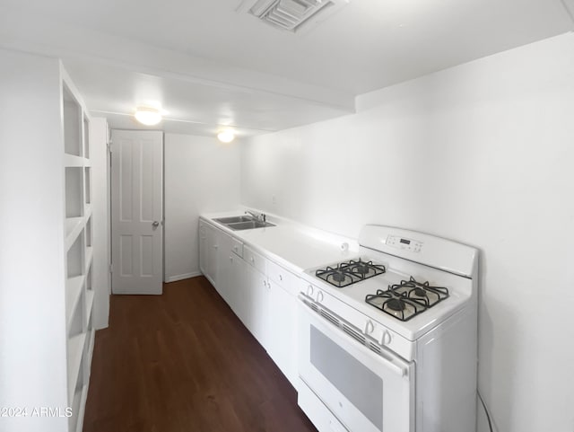 kitchen featuring sink, white range with gas stovetop, dark wood-type flooring, and white cabinetry