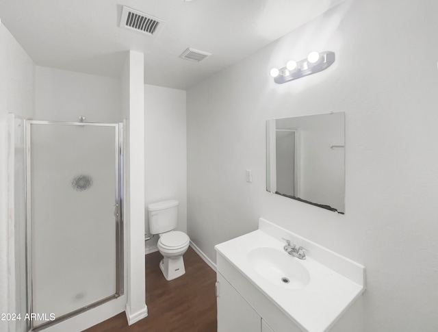 bathroom featuring a shower with shower door, toilet, vanity, and hardwood / wood-style flooring