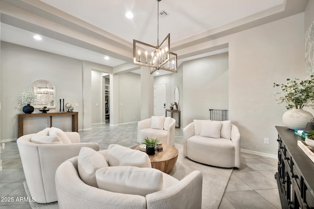 living room with light tile patterned floors, a raised ceiling, and a chandelier