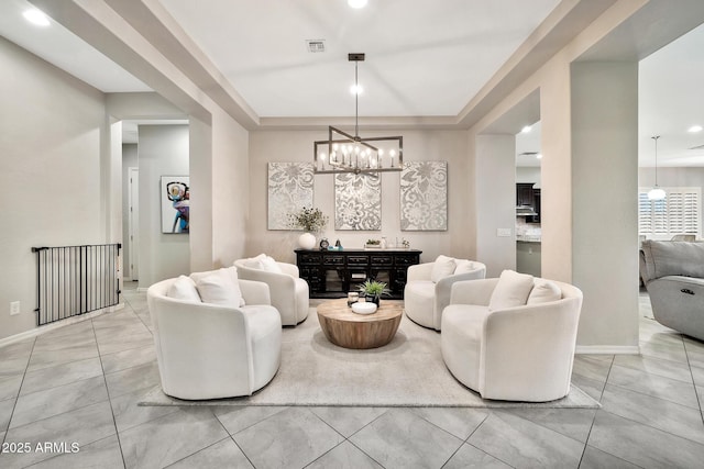 tiled living room featuring a chandelier