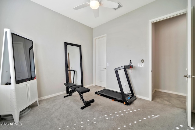 exercise room with ceiling fan and light carpet