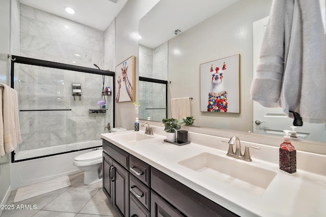 full bathroom featuring vanity, tile patterned flooring, enclosed tub / shower combo, and toilet