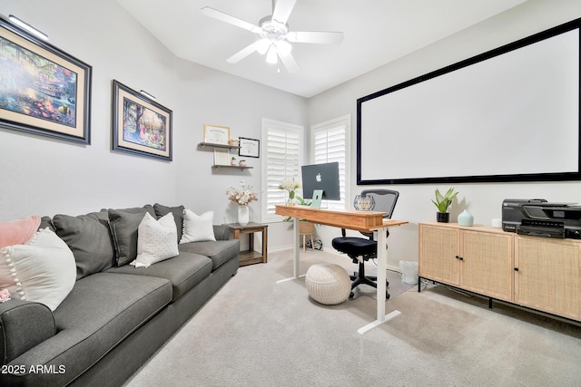 carpeted office featuring ceiling fan