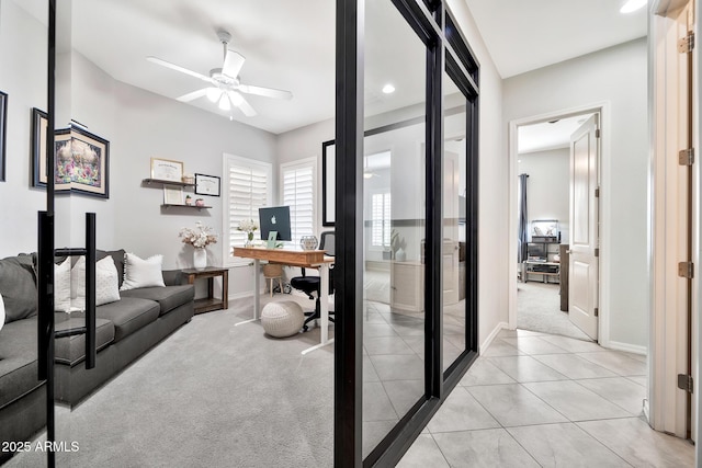 carpeted office featuring ceiling fan