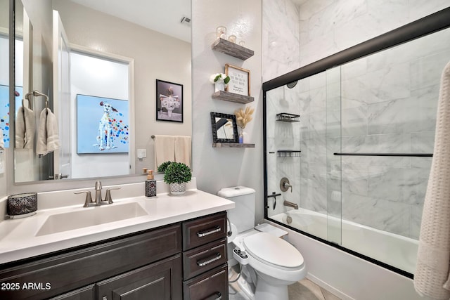 full bathroom featuring vanity, shower / bath combination with glass door, and toilet