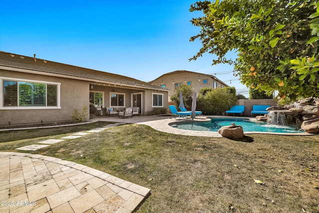 view of swimming pool featuring pool water feature, a patio area, and a lawn