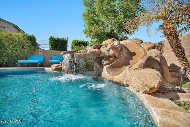 view of swimming pool with pool water feature