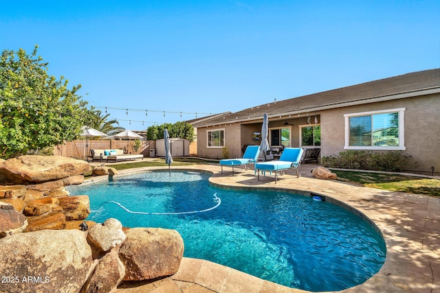 view of swimming pool with an outdoor hangout area, a patio area, and a shed