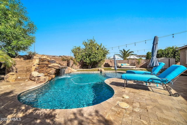 view of swimming pool featuring a storage shed, a patio, and pool water feature