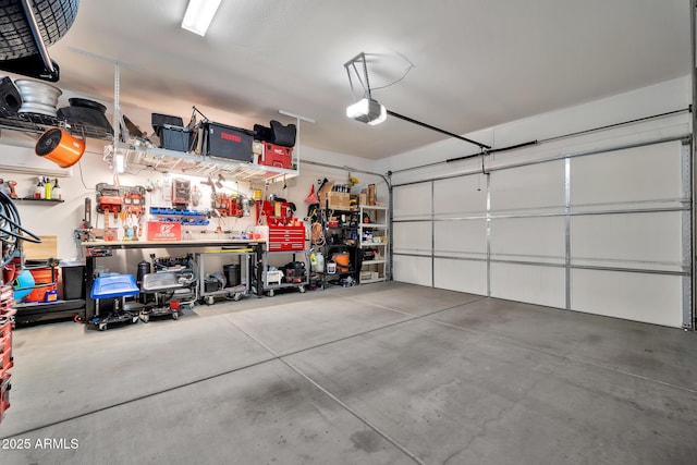 garage with a garage door opener and a workshop area