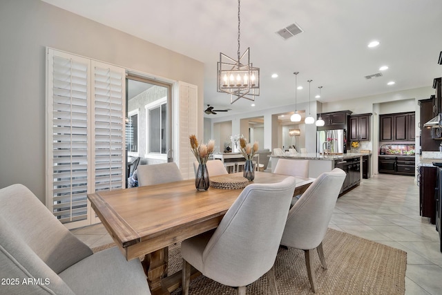 tiled dining room featuring a chandelier