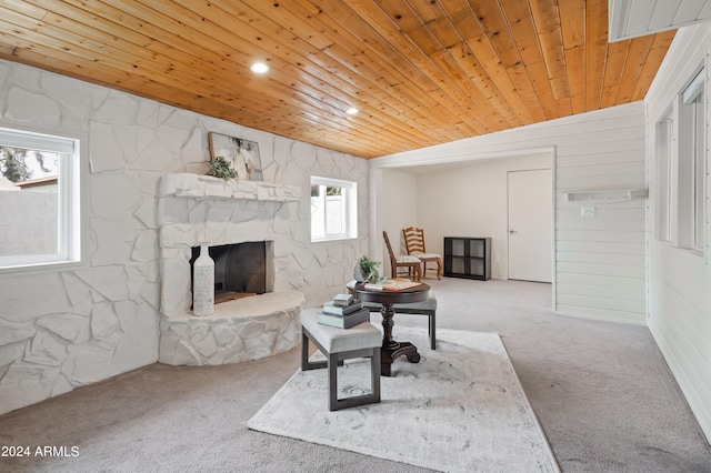 living room with wood ceiling, carpet floors, and a fireplace