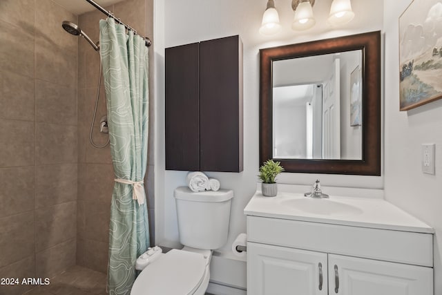 bathroom with curtained shower, toilet, and vanity