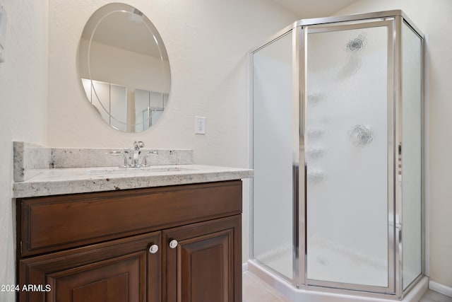 bathroom featuring vanity and an enclosed shower