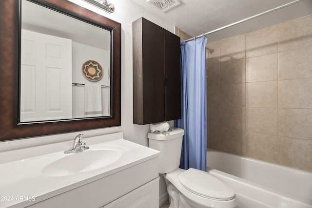 full bathroom featuring toilet, shower / tub combo with curtain, a textured ceiling, and vanity