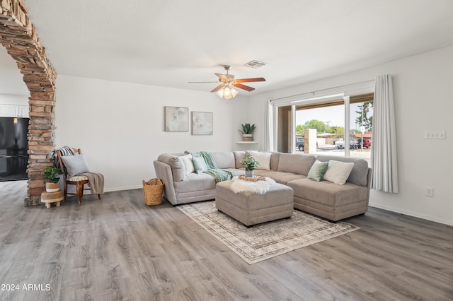 living room featuring light wood-type flooring and ceiling fan