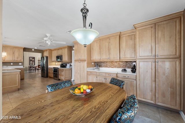 dining room featuring light tile patterned floors, visible vents, and a ceiling fan