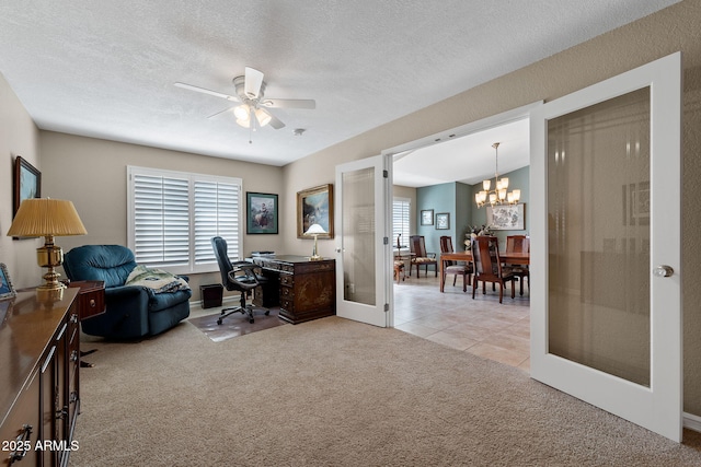 home office with french doors, light tile patterned floors, light carpet, a textured ceiling, and ceiling fan with notable chandelier