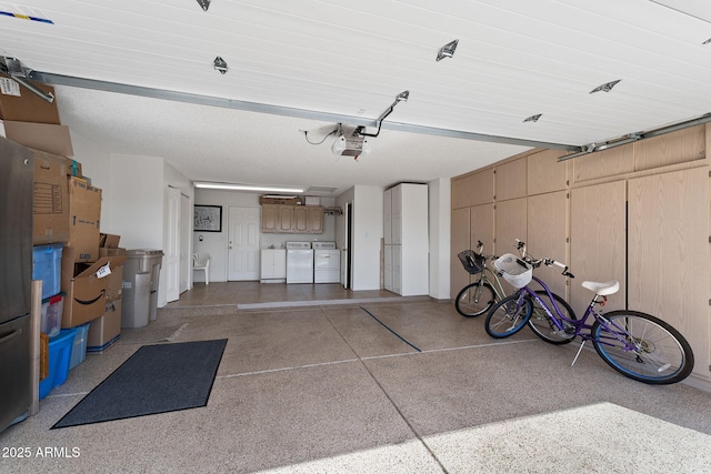 garage featuring washing machine and dryer and a garage door opener