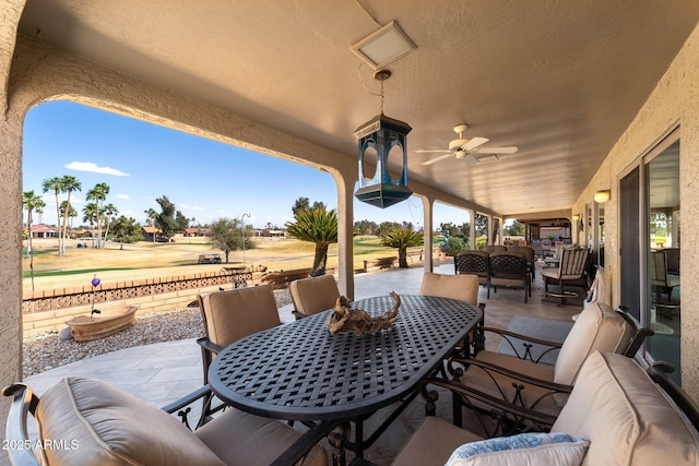 view of patio featuring an outdoor hangout area, outdoor dining area, and a ceiling fan