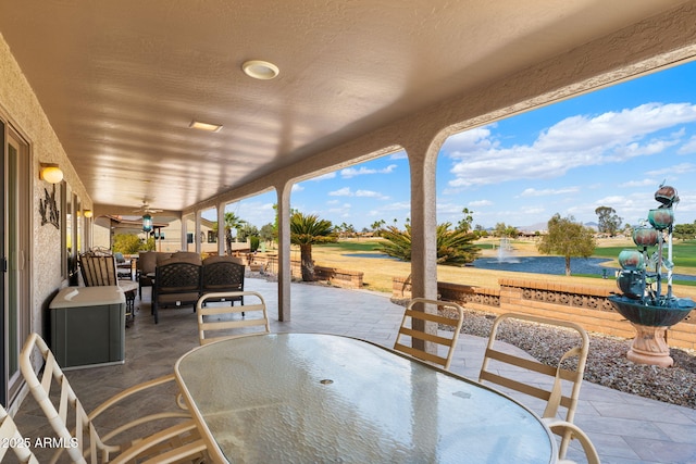 view of patio / terrace featuring a ceiling fan, outdoor dining space, and an outdoor hangout area