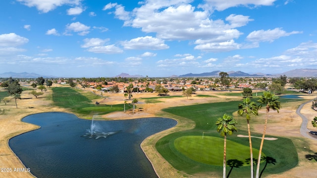 view of home's community with view of golf course and a water and mountain view