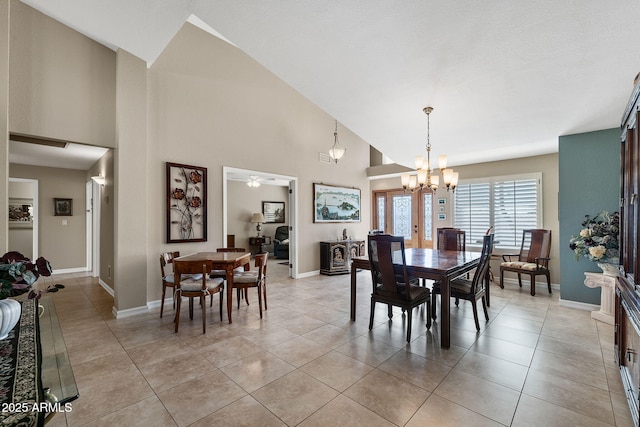 dining room with high vaulted ceiling, light tile patterned floors, baseboards, and ceiling fan with notable chandelier