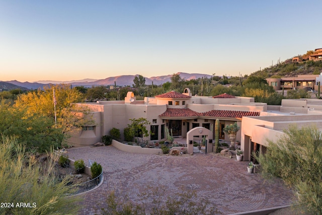 back house at dusk with a mountain view