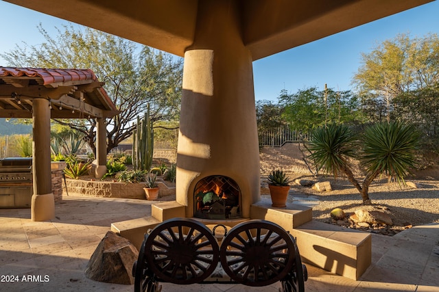 view of patio with exterior fireplace