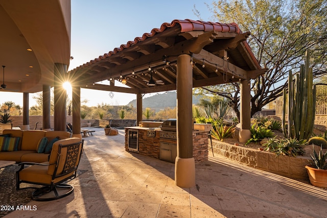 view of patio / terrace with area for grilling, a mountain view, a gazebo, grilling area, and an outdoor hangout area