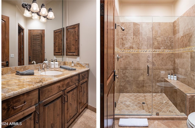 bathroom with a shower with shower door, vanity, and toilet