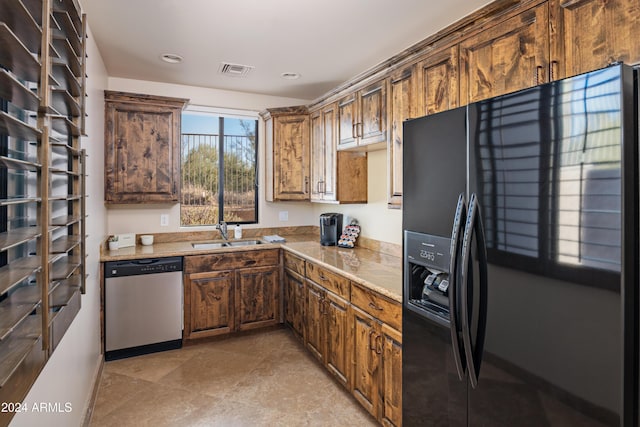 kitchen featuring sink, dishwasher, and black fridge with ice dispenser