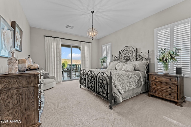 bedroom with a notable chandelier, light carpet, and access to exterior