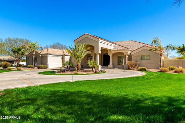 mediterranean / spanish home with stucco siding, a tile roof, fence, and a front yard