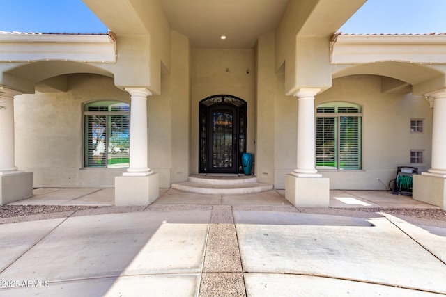 view of exterior entry with stucco siding