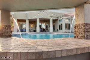 view of swimming pool featuring a patio area and a pool with connected hot tub