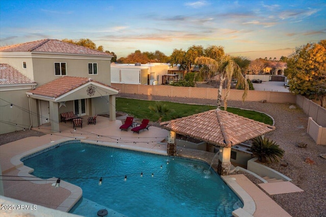 view of swimming pool with a fenced backyard, a fenced in pool, and a patio