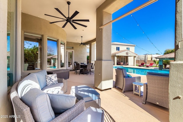 view of patio with a fenced in pool, outdoor dining area, an outdoor structure, and an outdoor living space