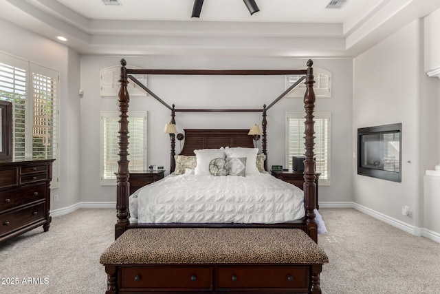 bedroom with light carpet, visible vents, and baseboards