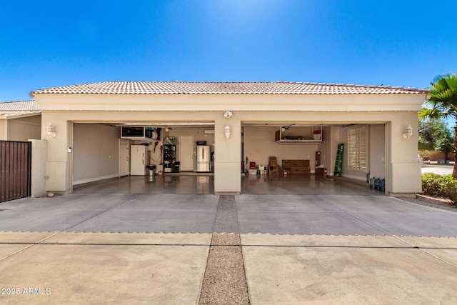 garage with water heater and concrete driveway