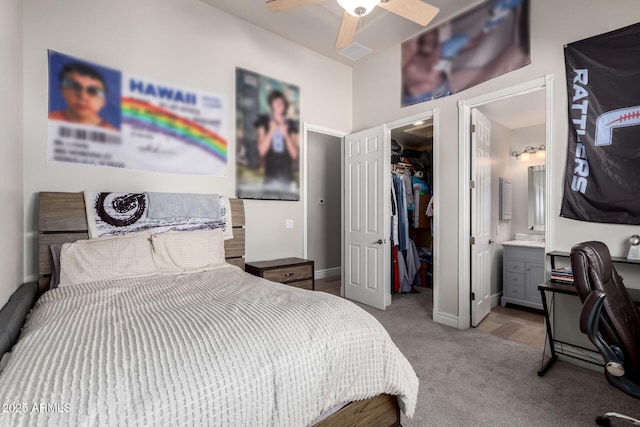 bedroom with baseboards, ensuite bathroom, a spacious closet, carpet floors, and a closet