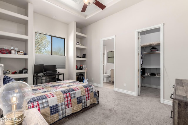 bedroom featuring carpet, a closet, a spacious closet, connected bathroom, and baseboards