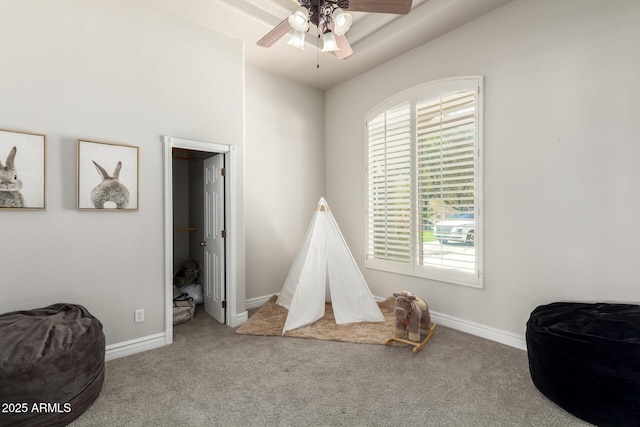 playroom with ceiling fan, carpet flooring, and baseboards