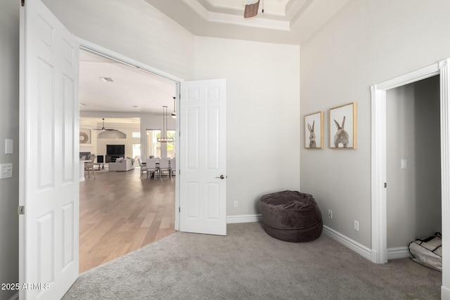 hall featuring carpet floors and baseboards