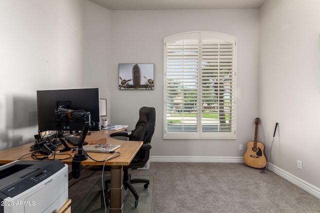 carpeted office space with baseboards