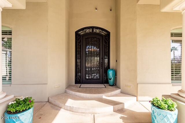 property entrance with stucco siding